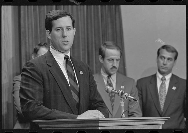 Representative Santorum in 1991. Representatives Frank Riggs and John Boehner stand behind him.