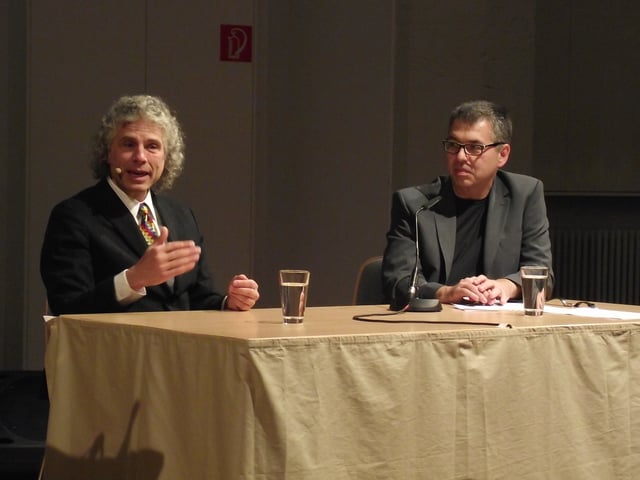Pinker and Nils Brose speaking at a neuroscience conference.