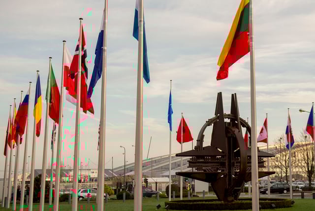 NATO country flags wave at the entrance of NATO Headquarters in Haren