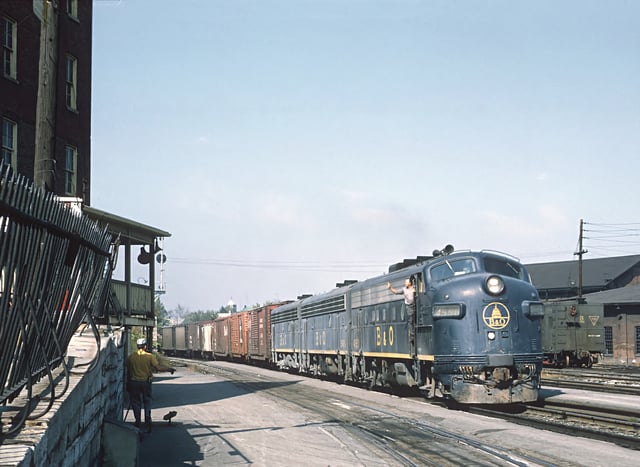 An engineer waves from a passing B&O freight train in 1969. The B&O's shops employed many locals throughout its 130 years of operation.