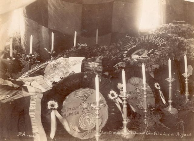 Courbet's coffin displayed in a chapelle ardente aboard Bayard, August 1885.  The coffin is covered in floral tributes from the French communities in Suez, Alexandria and other ports visited by Bayard during her voyage back to France.