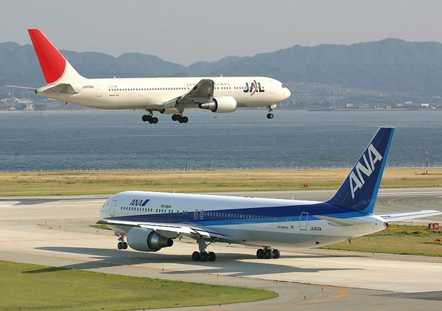 A JAL 767-300 lands in front of an ANA 767-300ER at Kansai Airport. The −300 and −300ER variants account for almost two-thirds of all 767s sold.