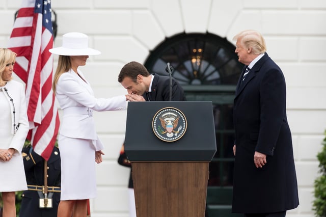 French President Macron greets Melania by kissing her hand, 2018