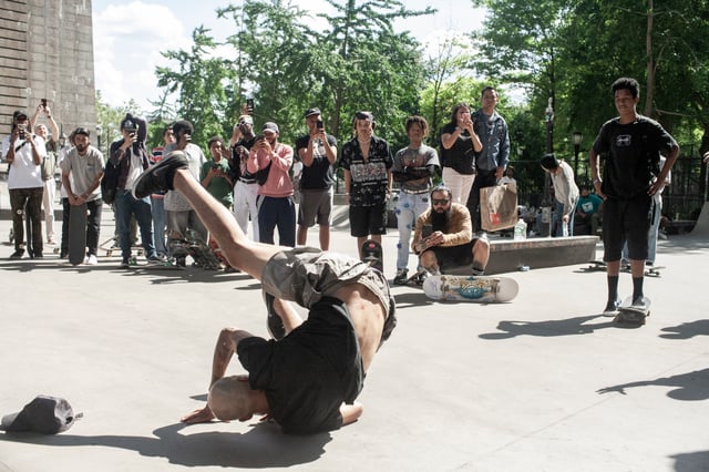 Spectators look on as Starlin Polanco gets up from an attempt during the best trick contest at Coleman Skatepark.