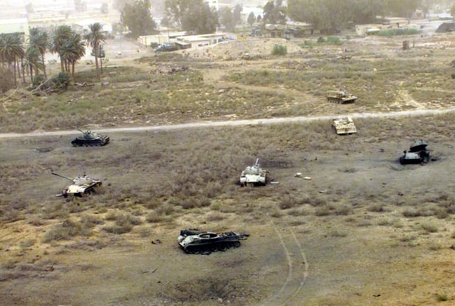 The destroyed remains of Iraqi tanks and other armored vehicles litter an Iraqi military complex west of Diwaniyah