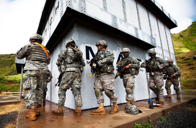 Soldiers of E Company, 100th Battalion, 442nd Infantry prepare to clear the "shoot house" while training in Hawaii in 2011.