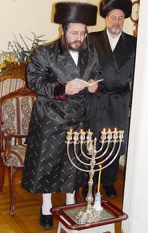 Biala Rebbe lights the menorah