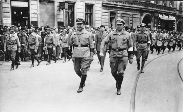 Communist Party (KPD) leader Ernst Thälmann (person in foreground with raised clenched fist) and members of the Roter Frontkämpferbund (RFB) marching through Berlin-Wedding, 1927