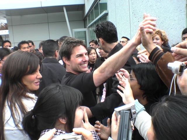 Cruise and Katie Holmes interacting with fans in March 2006