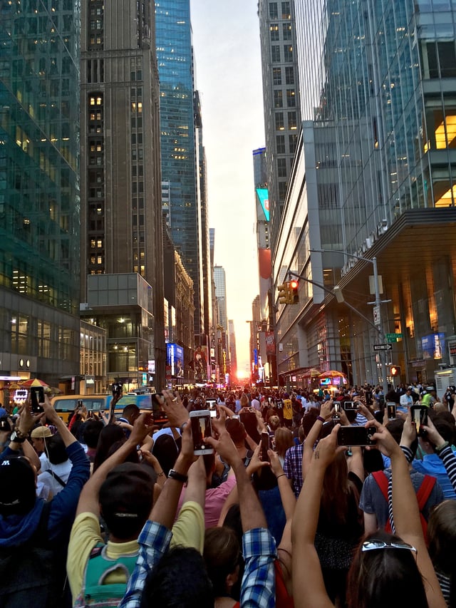 Tourists looking westward at sunset to observe the July 12, 2016 Manhattanhenge