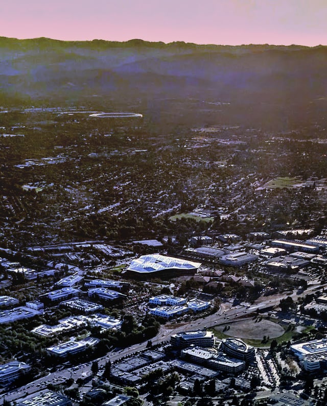 Aerial view of the new Nvidia headquarters building and surrounding campus and area in Santa Clara, California, in 2017. Apple Park is visible in the distance.