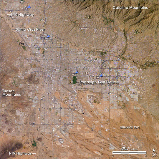 Tucson, as seen from space. The four major malls are indicated by blue arrows.