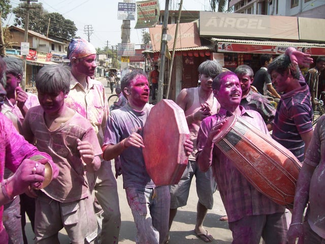 Friends form groups on Holi, play drums and music, sing and dance, as they move from one stop to another.