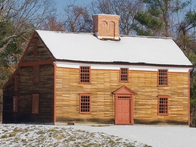 Captain William Smith House at Minute Man National Historical Park, a restored saltbox style house with unpainted clapboard siding