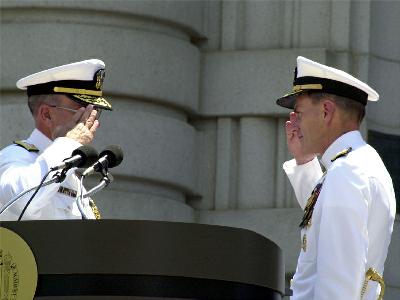 Admirals Jay L. Johnson and  Vern Clark of the United States Navy salute each other during a change of command ceremony. Clark is replacing Johnson as Chief of Naval Operations.