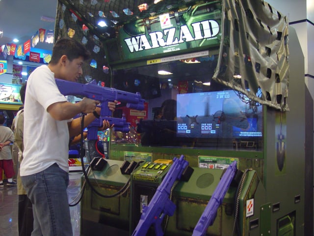 A man playing World Combat (here known by its alternate name Warzaid) in Jakarta, Indonesia