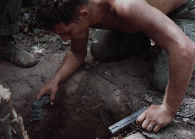 A US "tunnel rat" soldier prepares to enter a Viet Cong tunnel.