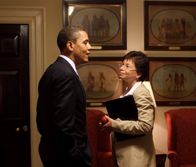 Obama speaks with Jarrett in a West Wing corridor