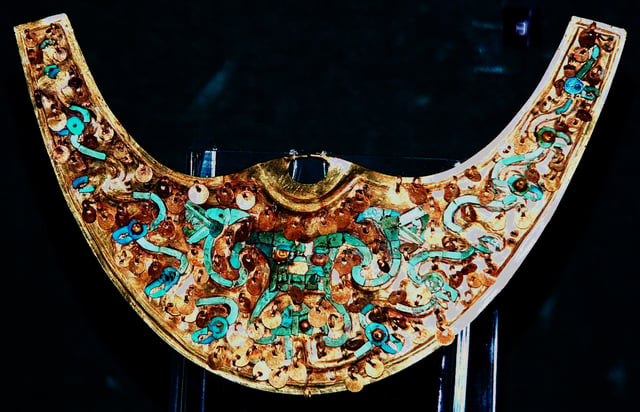 Moche Nariguera depicting the Decapitator, gold with turquoise and chrysocolla inlays. Museo Oro del Peru, Lima