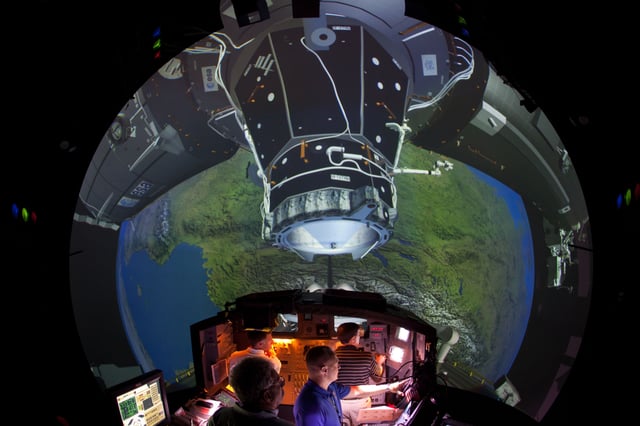 The Crew of STS-135 practices rendezvous and docking with the ISS in the Systems Engineering Simulator at the Johnson Space Center on June 28, 2011 in Houston, Texas.