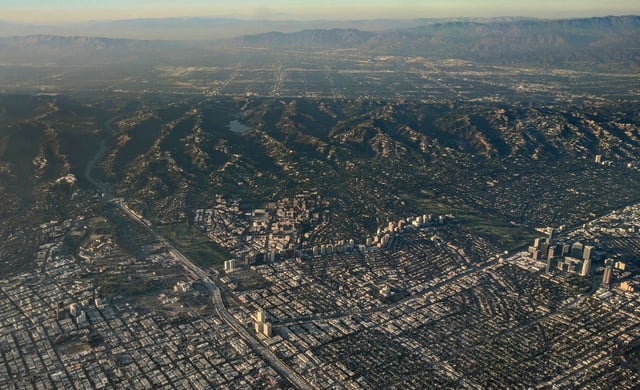 Late afternoon aerial photograph of Westwood (center), with Century City at the far right and the Santa Monica Mountains and San Fernando Valley in the background