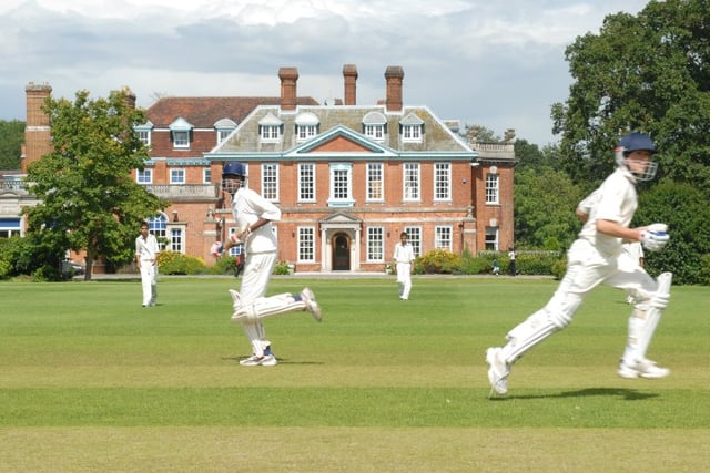 Boys playing cricket in front of Aldenham House