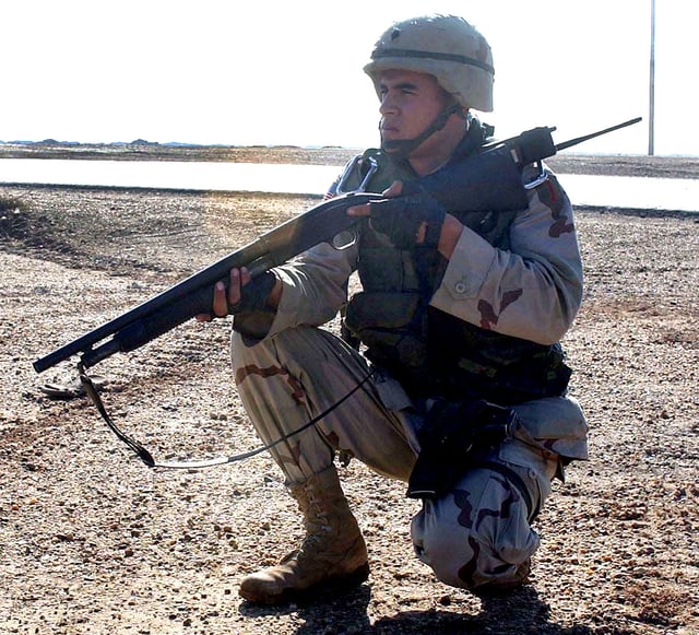 A United States Army soldier armed with a Mossberg 500 shotgun