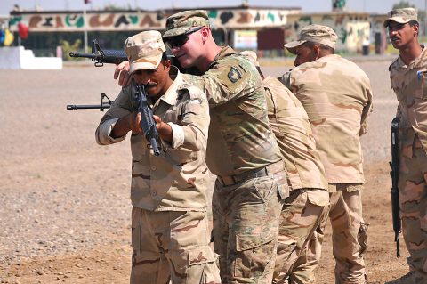 A trainer with Company A, 1st Battalion 502nd Infantry Regiment, Task Force Strike, 101st Airborne Division assists Iraqi army ranger students during a room clearing drill at Camp Taji, Iraq 18 July 2016.
