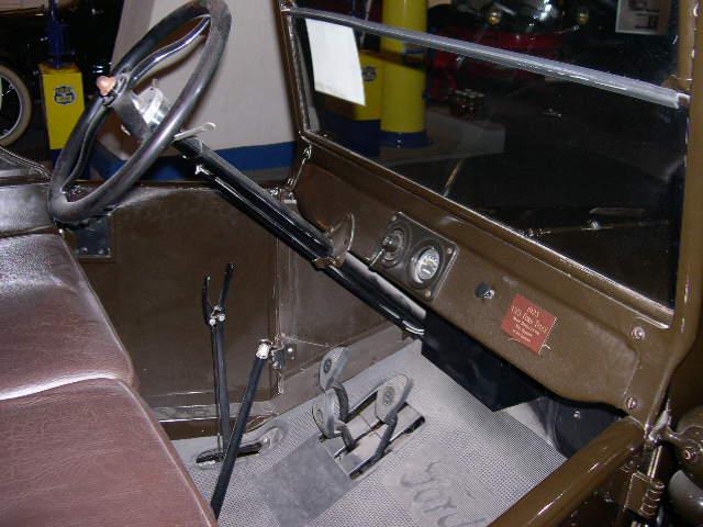 In the Ford Model T the left-side hand lever sets the rear wheel parking brakes and puts the transmission in neutral. The lever to the right controls the throttle. The lever on the left of the steering column is for ignition timing. The left foot pedal changes the two forward gears while the centre pedal controls reverse. The right pedal is the brake.