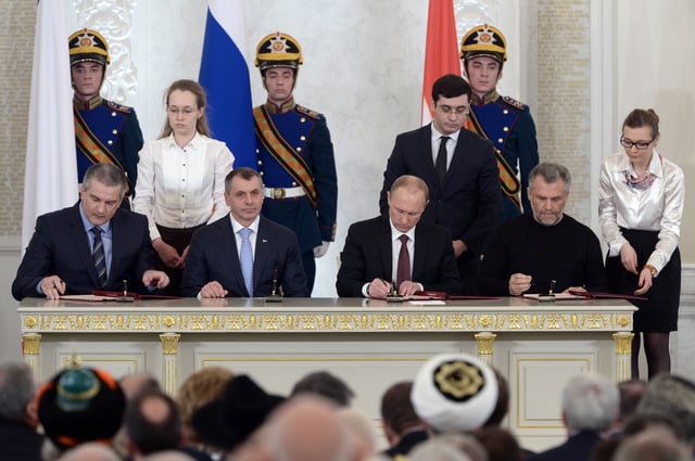 Vladimir Putin (third, left), Sergey Aksyonov (first, left), Vladimir Konstantinov (second, left) and Aleksei Chalyi (right) sign the Treaty on Accession of the Republic of Crimea to Russia in 2014