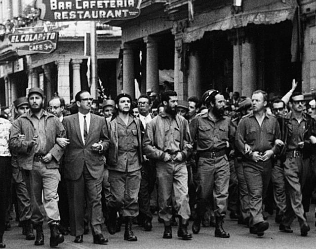 Castro (far left), Che Guevara (center), and other leading revolutionaries marching through the streets in protest over the La Coubre explosion, 5 March 1960