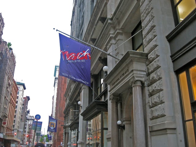 A Tisch School flag (with an older logo) displayed at the building's main entrance, c. 2007.