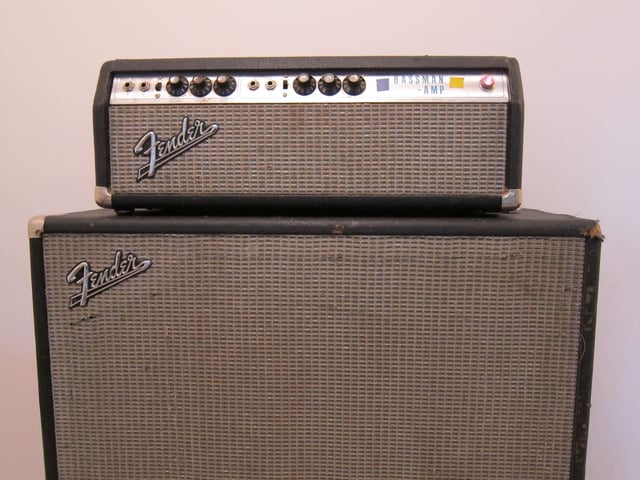A Fender Bassman amp head with a 15" speaker cabinet.