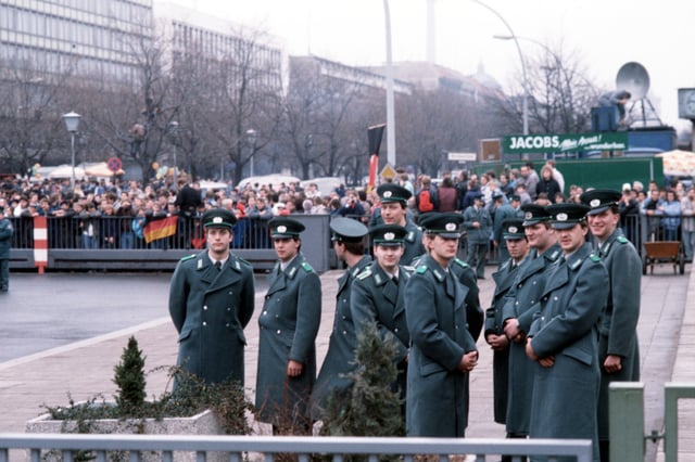 Police cadets of the East German Volkspolizei waiting for the official opening of the Brandenburg Gate on 22 December 1989