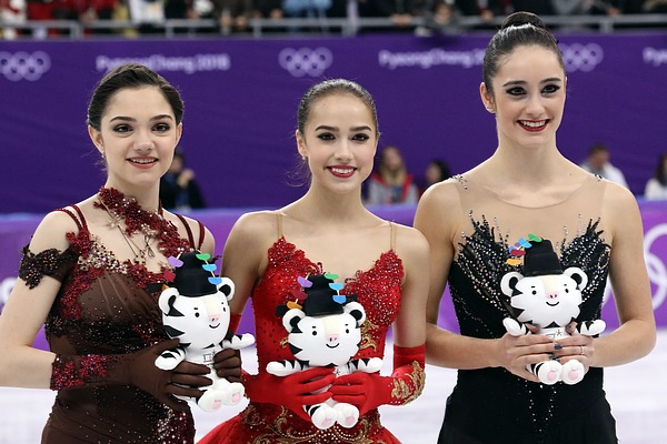 Medvedeva (left) with Alina Zagitova (center) and Kaetlyn Osmond (right) at the 2018 Winter Olympics podium.