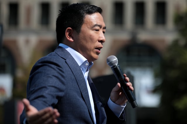 Yang speaks with supporters at the Des Moines Register's Political Soapbox at the 2019 Iowa State Fair in Des Moines, Iowa.