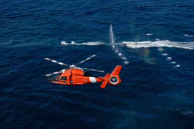 This is a demonstration of warning shots fired at a non-compliant boat by a USCG HITRON MH-65C and its M240 machine gun.
