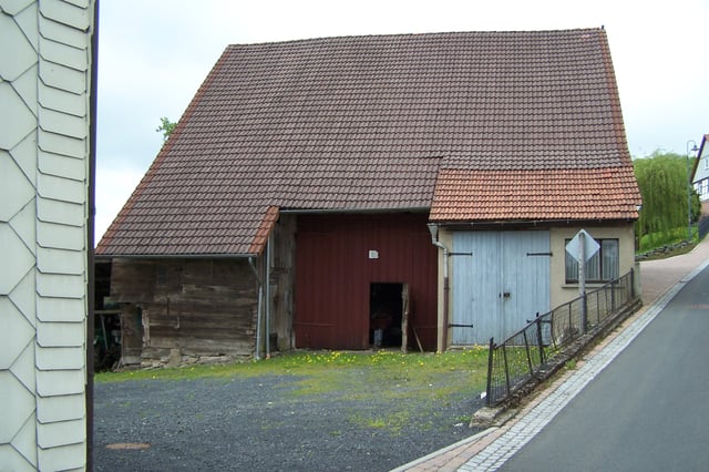 This barn in Thuringia, Germany has two outshots forming the recess to the middle barn doors.