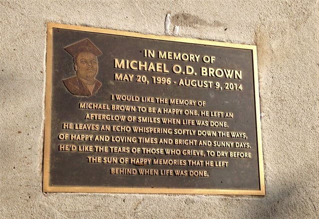 Bronze plaque in memory of Michael Brown on sidewalk where shooting incident occurred