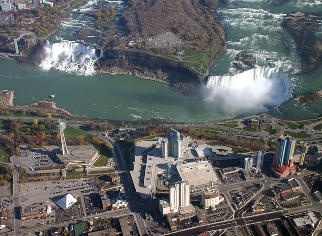 Two portions of Niagara Falls. The American Falls is on the left in New York; the Horseshoe Falls on the right separates New York from Ontario.