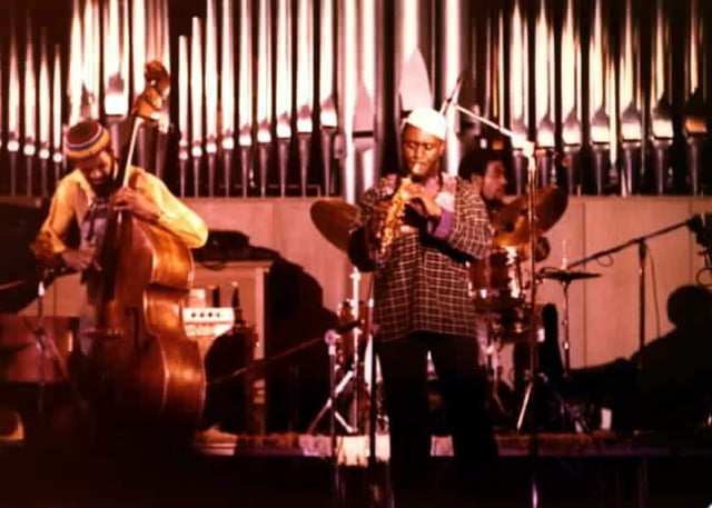 Jazz group consisting of double bassist Reggie Workman, tenor saxophone player Pharoah Sanders, and drummer Idris Muhammad, performing in 1978