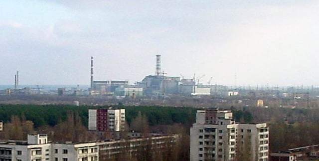 Pripyat with the Chernobyl Nuclear Power Plant in the distance