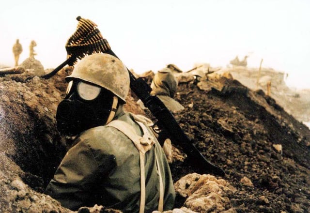 Iranian soldier with chemical mask at front-line of the Iran–Iraq War