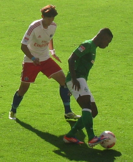 Heung-Min Son of Hamburg against Eljero Elia of Werder Bremen in the Nordderby