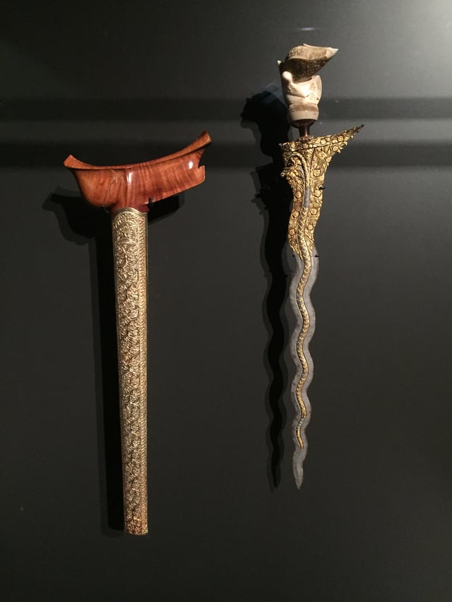 A Malay Keris, with its sheath on the left. This particular dagger was historically belonged to a Malay aristocrat from Sumatra.