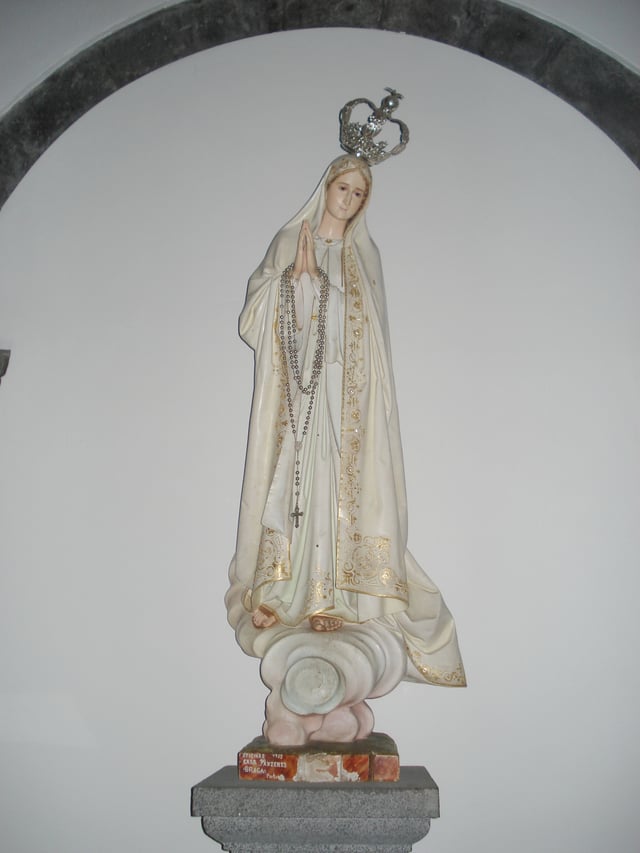 Statue of Our Lady of Fátima in the Church of Santa María Madalena, Madalena, the Azores, 2007. The devotion is especially popular among Catholics in Lusophone countries and the Portuguese diaspora.