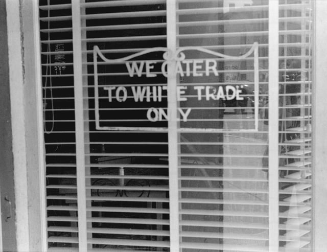 "We Cater to White Trade Only" sign on a restaurant window in Lancaster, Ohio, in 1938. In 1964 Martin Luther King Jr. was arrested and spent a night in jail for attempting to eat at a white-only restaurant in St. Augustine, Florida
