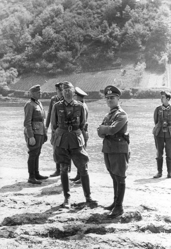 General Erwin Rommel and his staff observe troops of the 7th Panzer Division practicing a river crossing at the Moselle River in France in 1940.