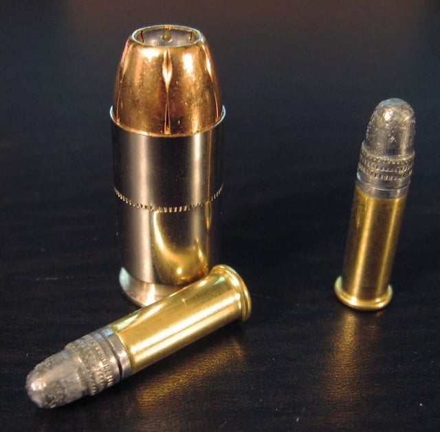 Two .22 LR rounds compared to a .45 ACP cartridge
