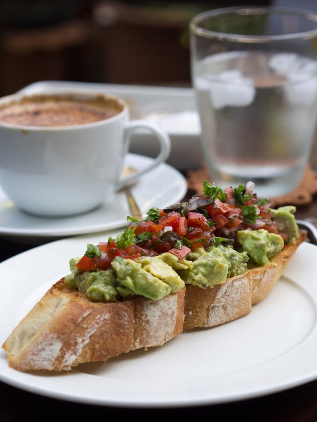 Avocado salad, and a tomato and black olive salsa, on a toasted baguette